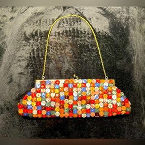 Aldo all over multi-colored button clutch with chain strap.